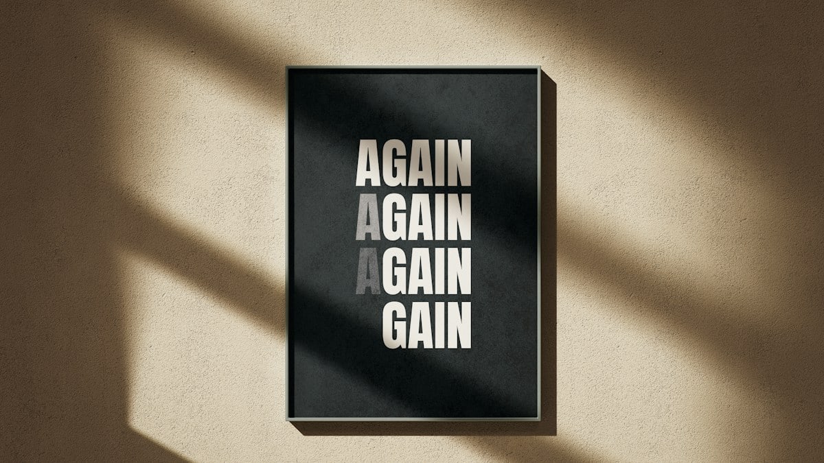 A black and white poster hanging on a wall